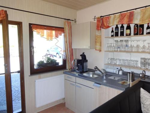 a kitchen with a sink and a window at Landhaus Erna in Böbrach