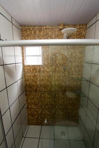 a shower with a glass door in a bathroom at Pousada da Leide in Fernando de Noronha