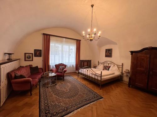 a living room with a bed and a couch at Hotel Kohlmayr in Gmünd in Kärnten