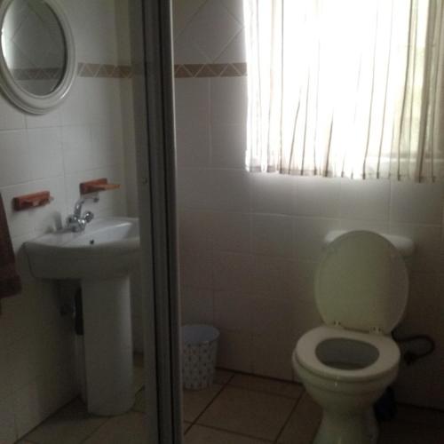 a bathroom with a toilet and a sink at For your family Manzini 1 in St Lucia