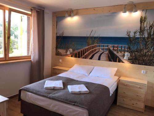 Katil atau katil-katil dalam bilik di Bałtyk Apartamenty Poddąbie