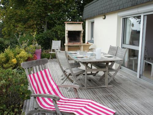 a wooden deck with a table and chairs on it at Holiday Home Gevanac by Interhome in Crozon