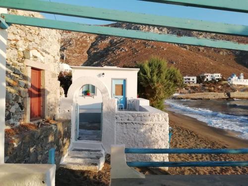 a house with a staircase to the beach at PARADISE ON THE KANTOUNI BEACH in Panormos Kalymnos
