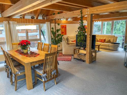 a living room with a wooden table and chairs at Chalet Christine by Interhome in Molberting