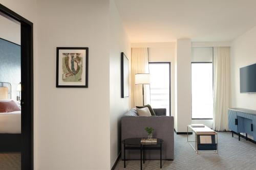 a living room with a couch and a bed at Kimpton Hotel Fontenot by IHG in New Orleans
