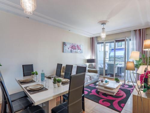 uma sala de jantar e sala de estar com mesa e cadeiras em Apartment Héraclès by Interhome em Nice