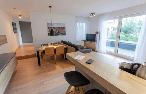 a living room with a table and a dining room at The Room in Regensburg