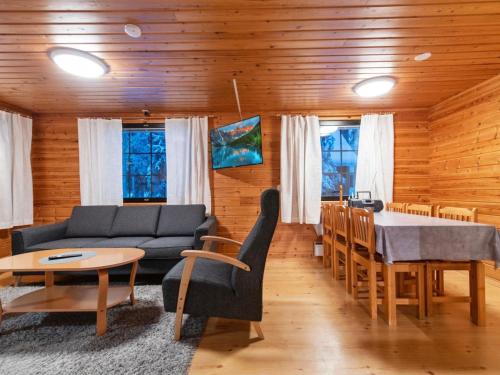 a living room with a couch and a table at Holiday Home Kaltiotievantie 2 mökki 3 by Interhome in Ylläsjärvi
