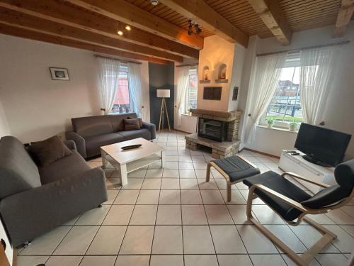 a living room with a couch and a table at Holiday Home Riedehuus by Interhome in Norddeich