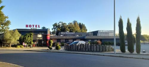 a hotel on the side of a street with a road at The Originals City, H&ocirc;tel Les Caps, Saint-Brieuc Est in Lamballe