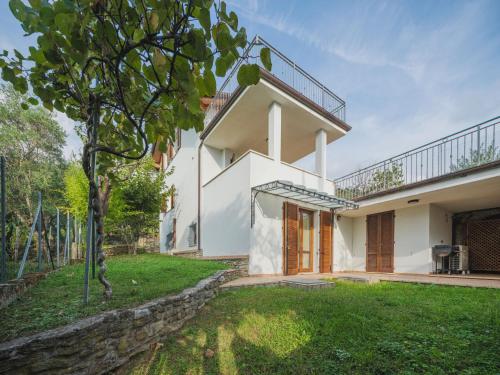 a white house with a tree in the yard at Holiday Home I Modellini by Interhome in Seravezza