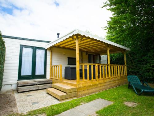 a wooden gazebo with a bench in a yard at Holiday Home Duinhoeve-1 by Interhome in Udenhout
