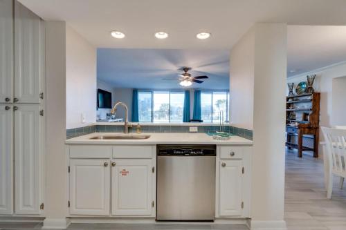 a kitchen with a sink and a dishwasher at Amazing Waterview Towers 104 Condo With Boat Slip in Destin