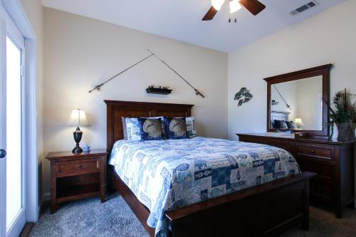 a bedroom with a bed and a large mirror at Amazing 4 Bedroom Vacation Home in The Villages of Crystal Lakes in Destin