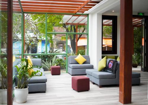 a lobby with couches and chairs in a building at Fuse Old Town Hoi An in Hoi An