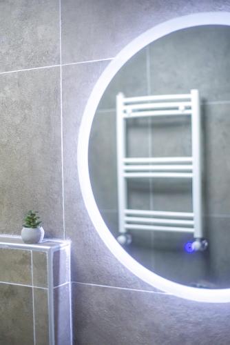 a mirror in a bathroom with a towel rack at LALO Hotel Abastumani in Abastumani