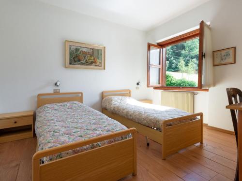 a bedroom with two beds and a window at Villa Villa Lucia by Interhome in Pellizzano