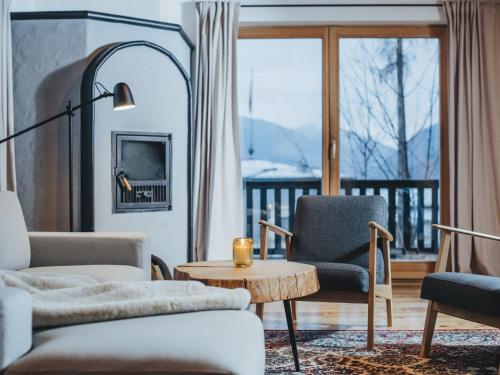 a living room with a couch and chairs and a table at Chalet Chalet 1018 by Interhome in Bad Gastein