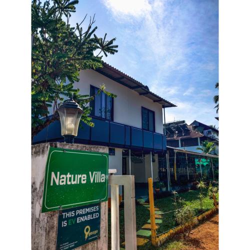 a sign in front of a house at Nature Villa Kochi in Alwaye