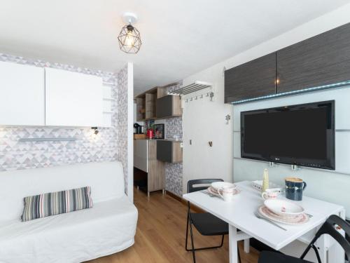 Habitación pequeña con cama blanca y mesa blanca. en Studio Palafour - Le Lac-6 by Interhome en Tignes