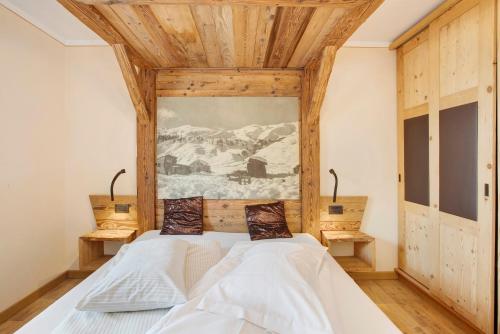 a bedroom with two beds and a painting on the wall at Appartamento1 deluxe - Alpen Suite in Livigno