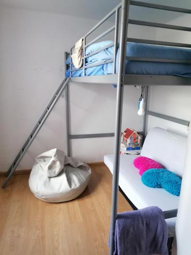 a dorm room with a bunk bed and a ladder at Casa Miky in Lanzada