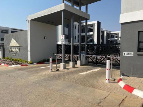 a parking lot in front of a building at Zanaya Apartments in Gaborone