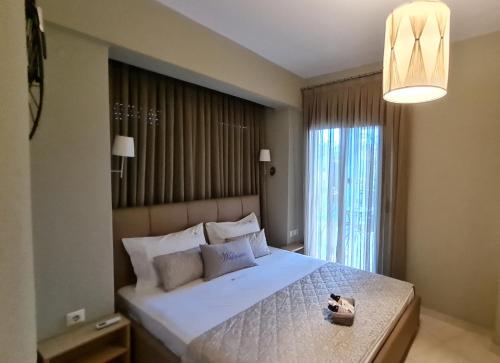 a bedroom with a large bed with a large window at Toroni Pearl in Toroni