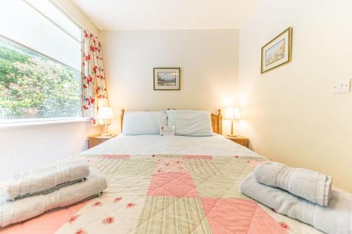 a bedroom with a large bed and a window at Hollin Bank Barn Coniston Water in Coniston