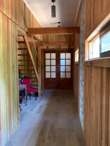 a hallway of a house with wooden walls and a door at Viejoboldo_latrinchera in Los Rábanos