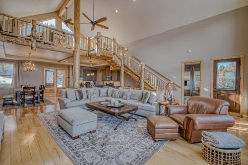 a living room with a couch and a staircase at Cutbow Lodge in South Fork