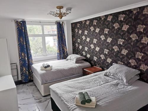 a bedroom with two beds and a window at Stylish and Modern Apartment close to Dover Port! in Kent