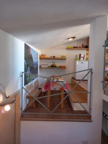 a staircase with a glass railing in a house at AFFITTACAMERE DORGALI B&B da ZIETTO in Dorgali