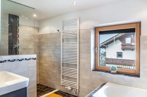 a bathroom with a sink and a window at Fewo Bergtroll in Uderns