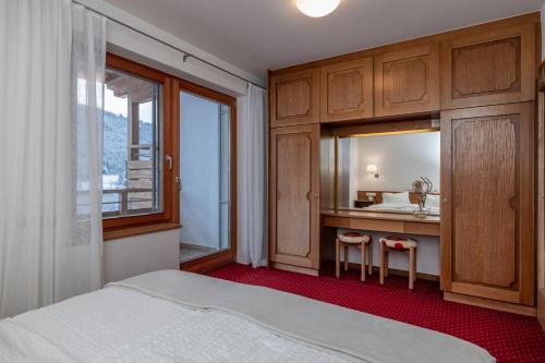 a bedroom with a bed and a vanity and a sink at Haus Sonnbichl in Weissensee