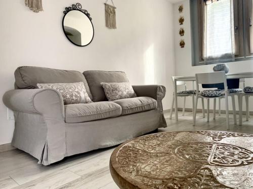a living room with a couch and a table at Casa Manila Isola d'Elba in Portoferraio
