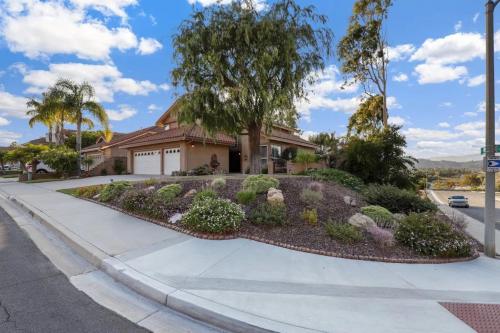 a house with a garden on a sidewalk at Casa Oasis/Pool & Jacuzzi/4 Bedroom/ Wi-Fi in Camarillo