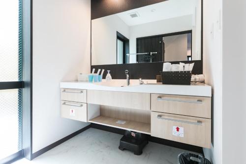 a bathroom with a sink and a mirror at Kyo no yado BOTAN in Kyoto