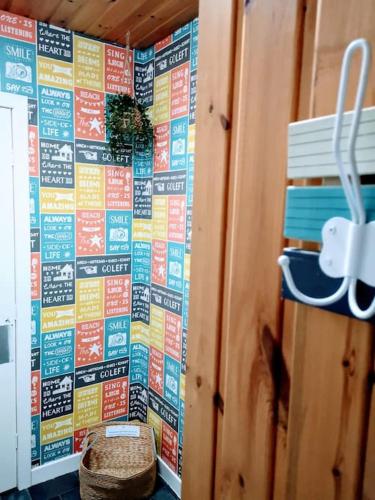a wall with a mural of signs on it at aabAlree Guest House in Dundee