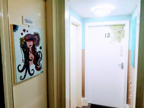 a painting of a octopus on the wall next to a door at aabAlree Guest House in Dundee