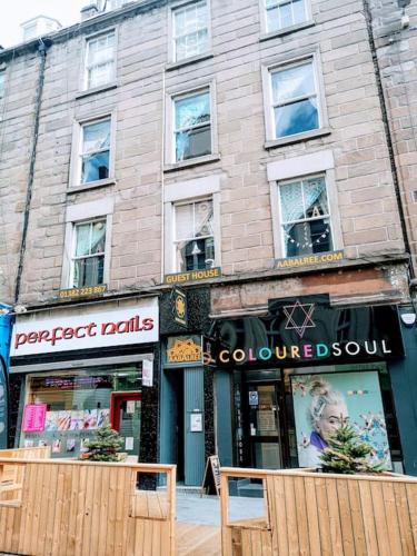 a building with a store on a city street at aabAlree Guest House in Dundee