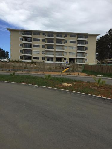 a large apartment building on the side of a street at condominio parquemar el tabo in El Tabo