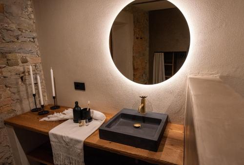 a bathroom with a black sink and a mirror at Relais Chiarene in Novello
