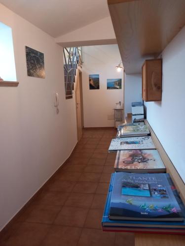 a room with a bunch of books on the floor at AFFITTACAMERE DORGALI B&B da ZIETTO in Dorgali