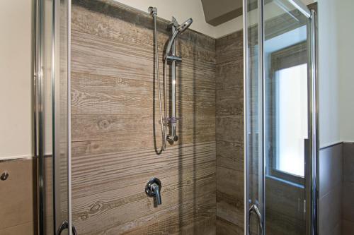 a bathroom with a shower with a glass door at Il Duomo Salerno in Salerno