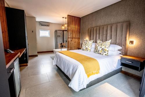 a bedroom with a large bed in a room at Beach Wood Boutique Hotel & Resort in Ballito