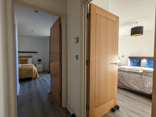 a room with a door leading to a bedroom at Bankside by Wycombe Apartments in High Wycombe