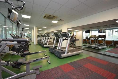 a gym with rows of treadmills and machines at Beautiful 1-Bed Apartment Central London in London