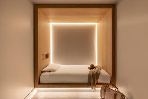 a room with a bed in a mirror at Zedwell Hotel Piccadilly Circus in London
