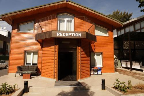 an orange building with a sign that reads reception at Istanbul Park Hotel in Tuzla